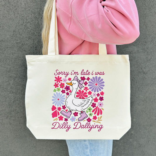 Tote bag with a sorry im late i was dilly dallying goose graphic and text on a gray background
