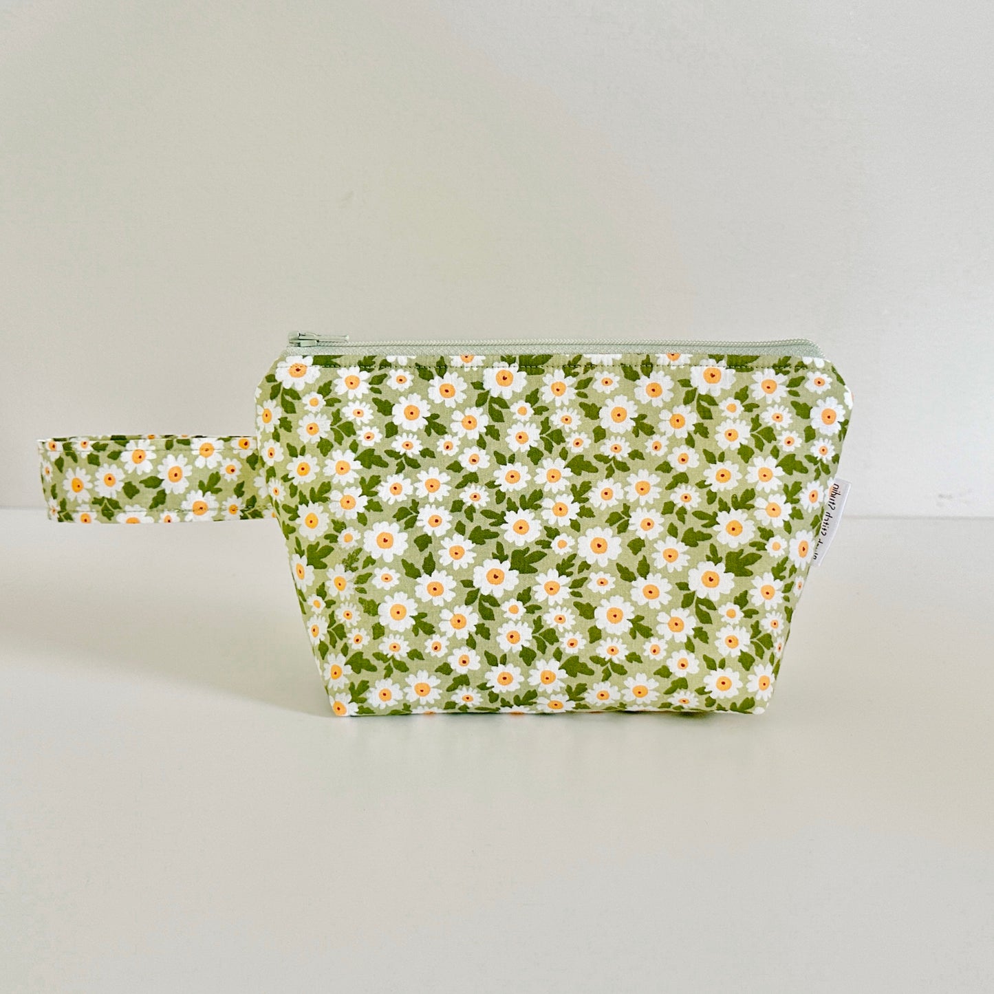 Floral-patterned pouch on a light gray background