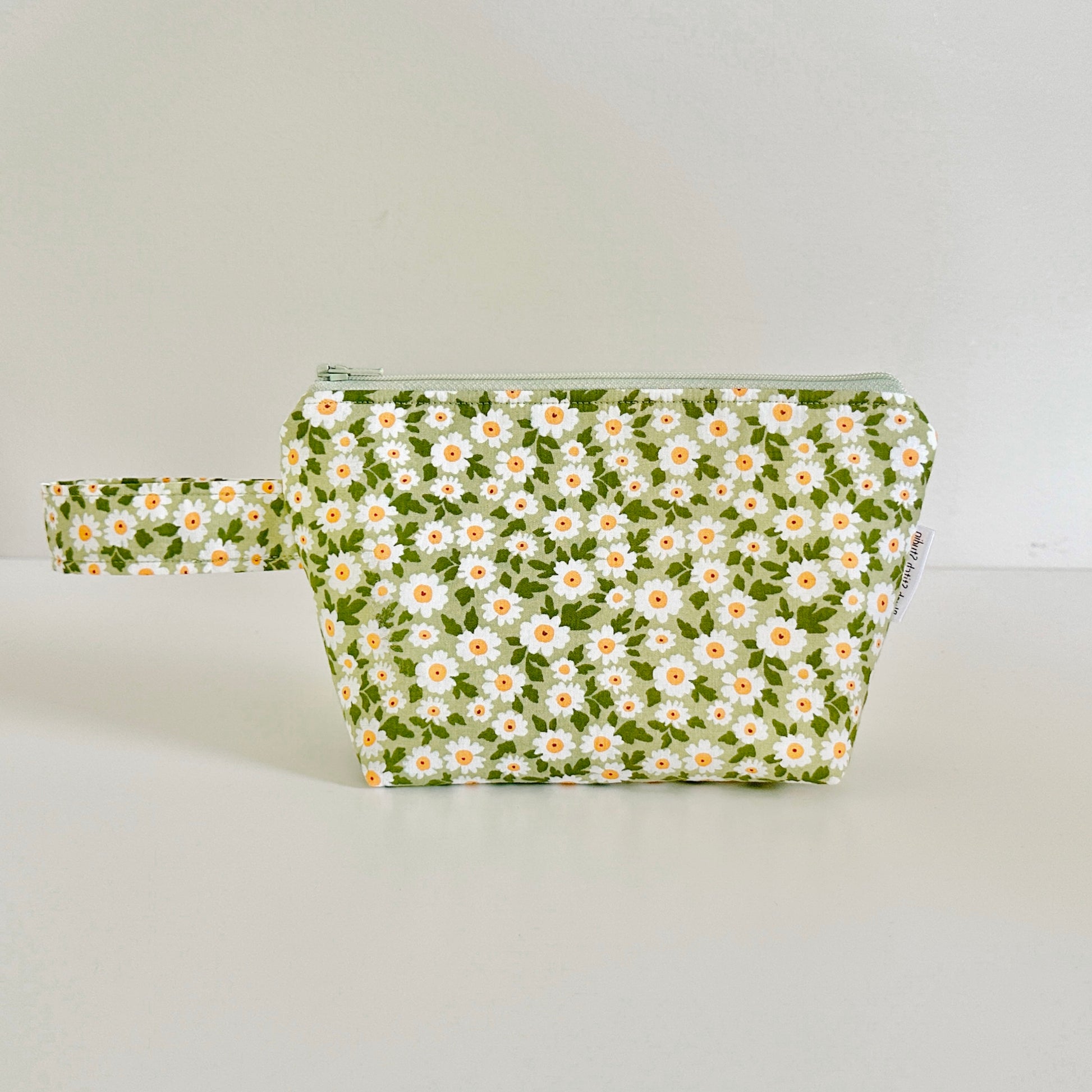 Floral-patterned pouch on a light gray background