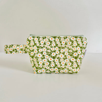 Floral-patterned pouch on a light gray background
