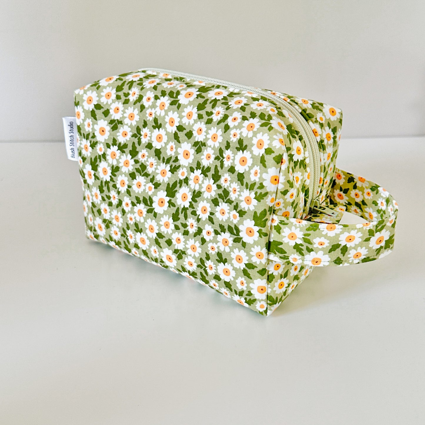 Floral-patterned pouch on a light gray background
