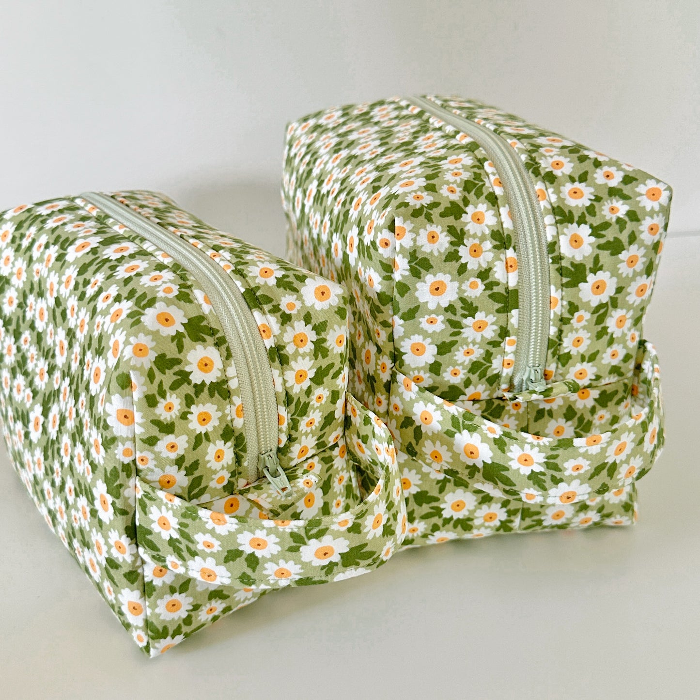 Two floral-patterned bags on a light background