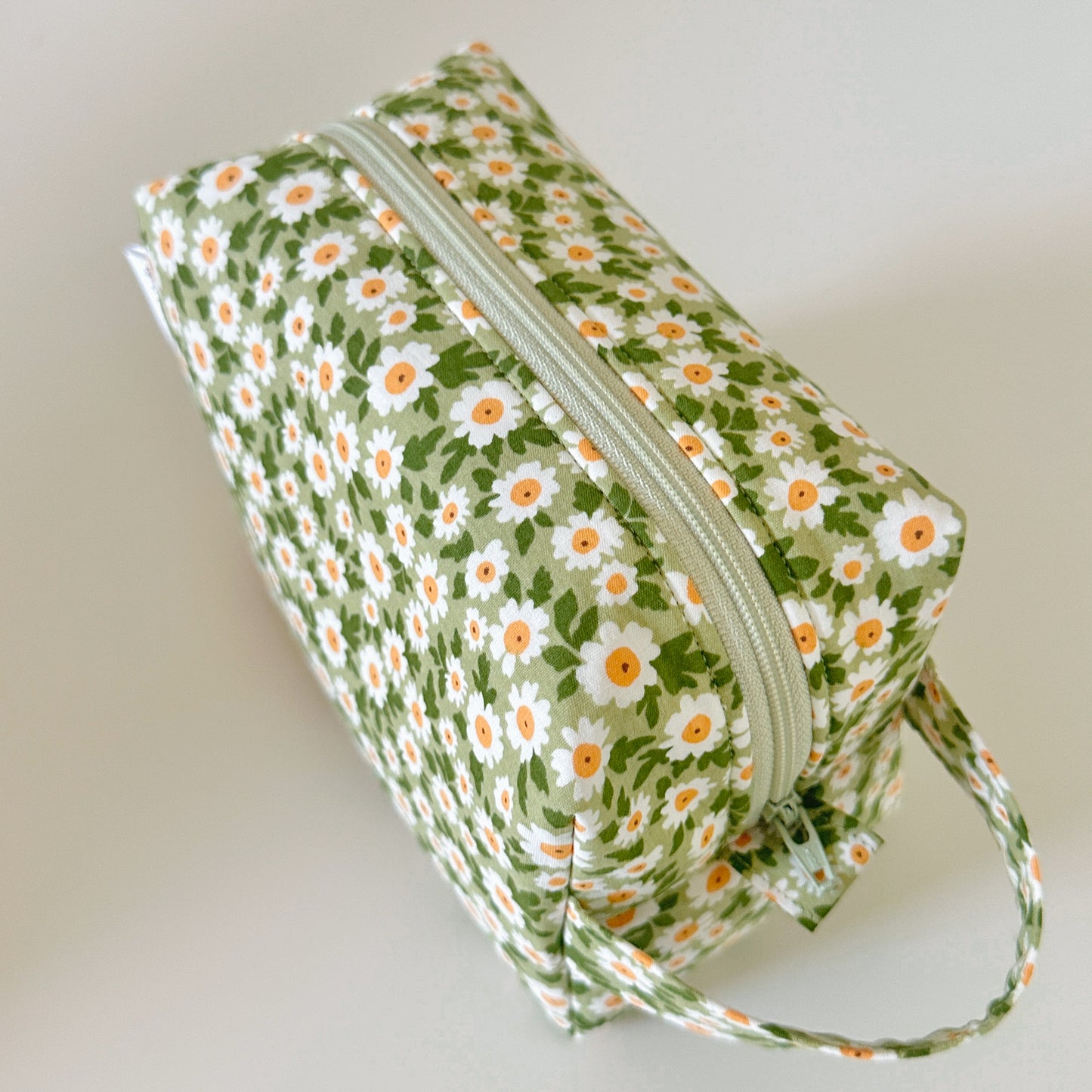 Floral-patterned pouch with a zipper on a light background