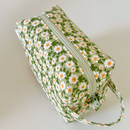 Floral-patterned pouch with a zipper on a light background