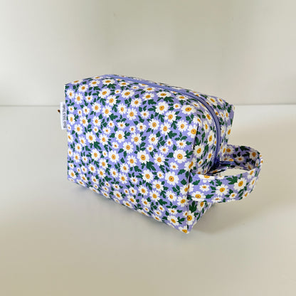 Floral-patterned toiletry bag on a light background