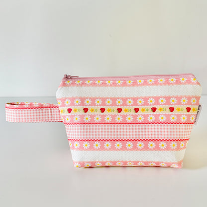 pink strawberry patterned makeup cosmetic bags on a white background