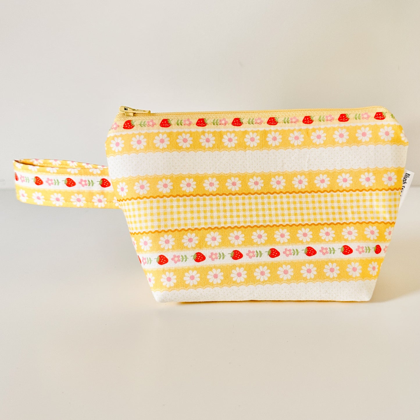 Yellow strawberry patterned bags on a white background