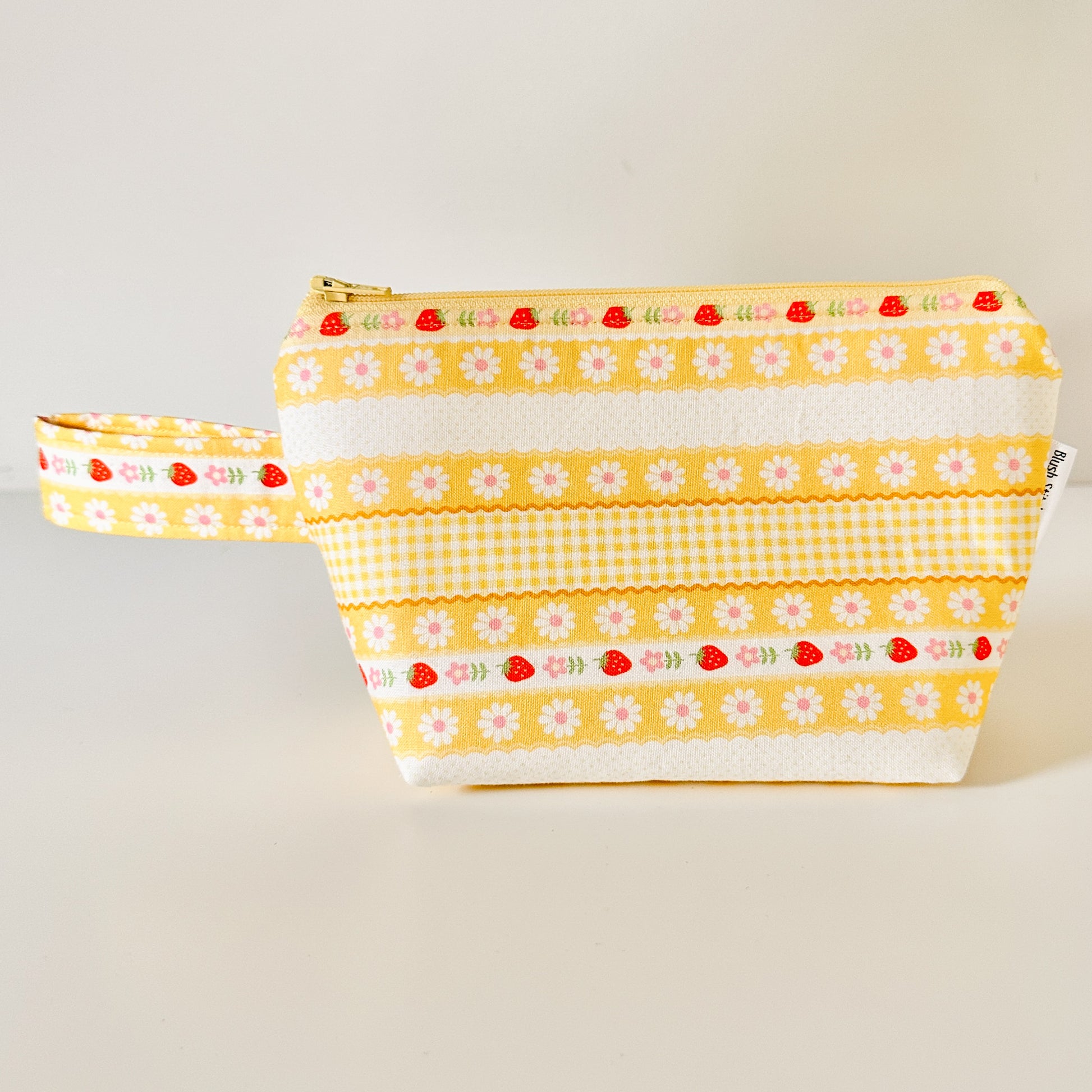 Yellow strawberry patterned bags on a white background