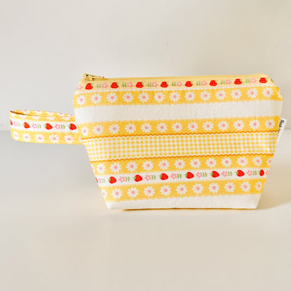 Yellow strawberry patterned bags on a white background