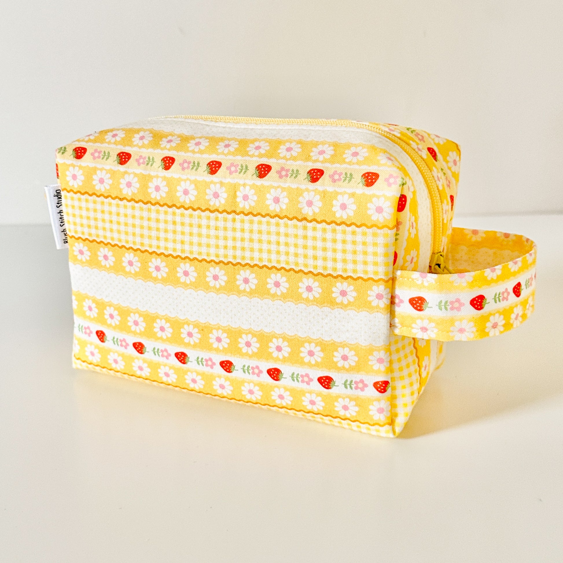 Yellow strawberry patterned bags on a white background