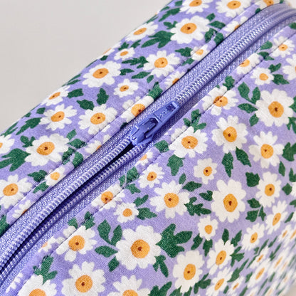 Floral-patterned bag with a zipper on a light gray background
