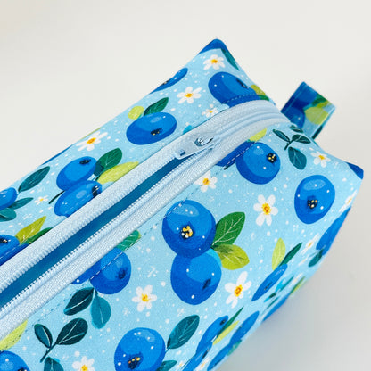 Fabric pouch with blueberry pattern on a light blue background
