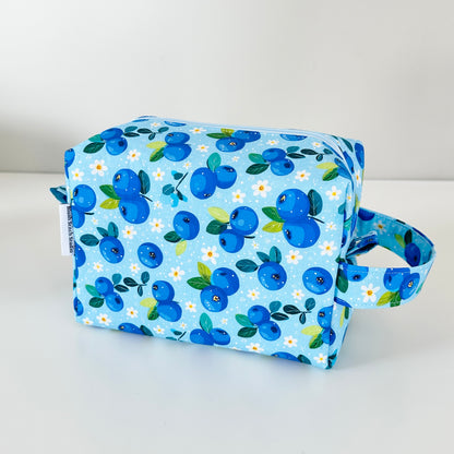 Fabric pouch with blueberry pattern on a white background