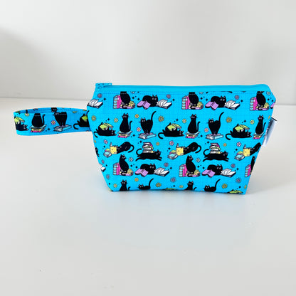 Blue pouch with black cat pattern on a white background