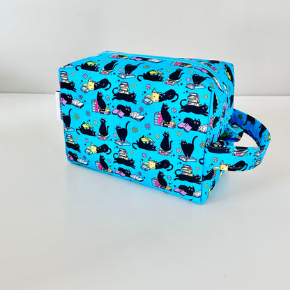 Blue fabric bag with black cat pattern on a white background
