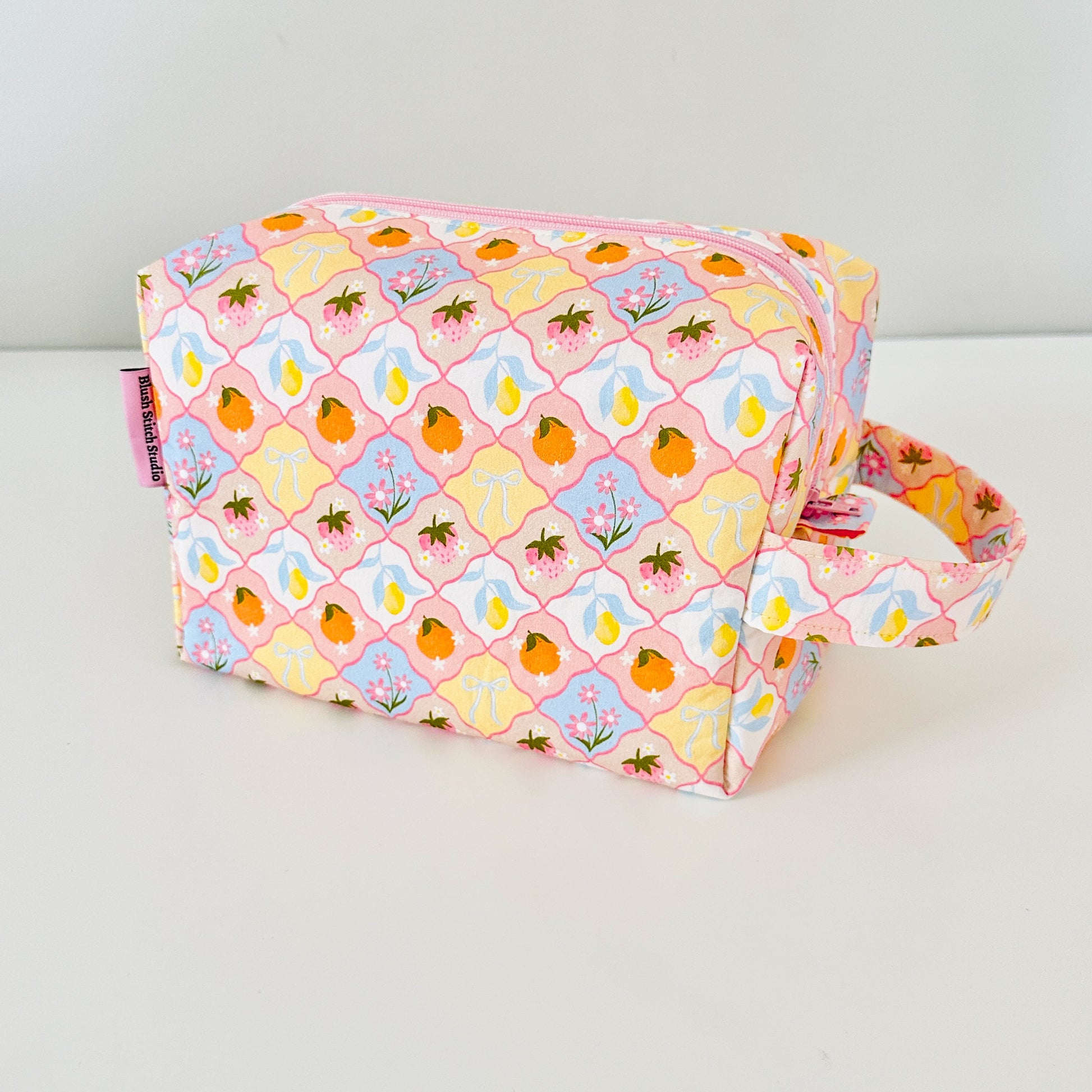Fabric pouch with a colorful pattern on a white background