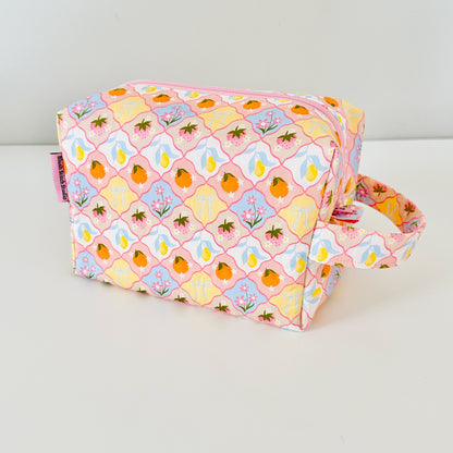 Fabric pouch with a colorful pattern on a white background