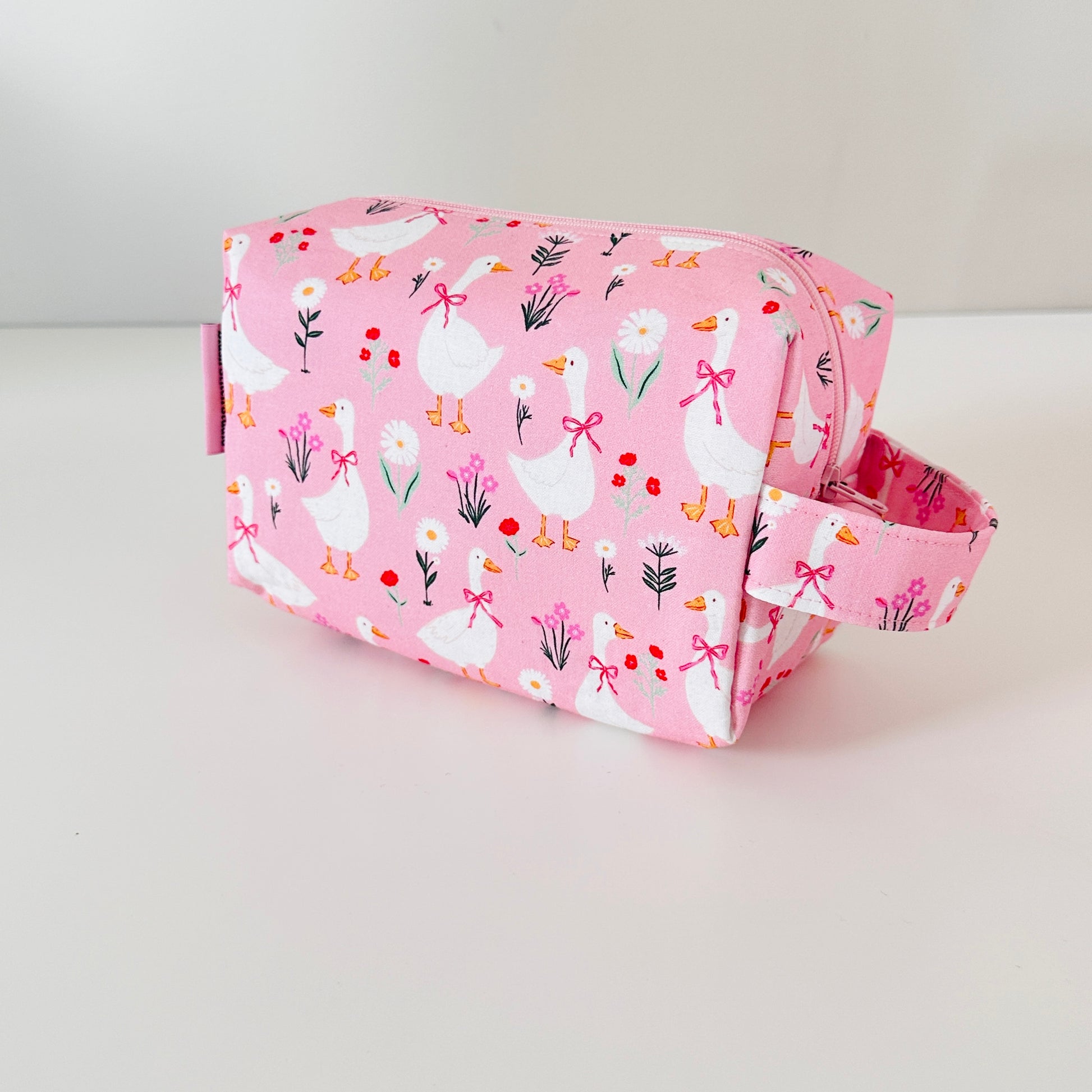 Pink bag with duck pattern on a white background