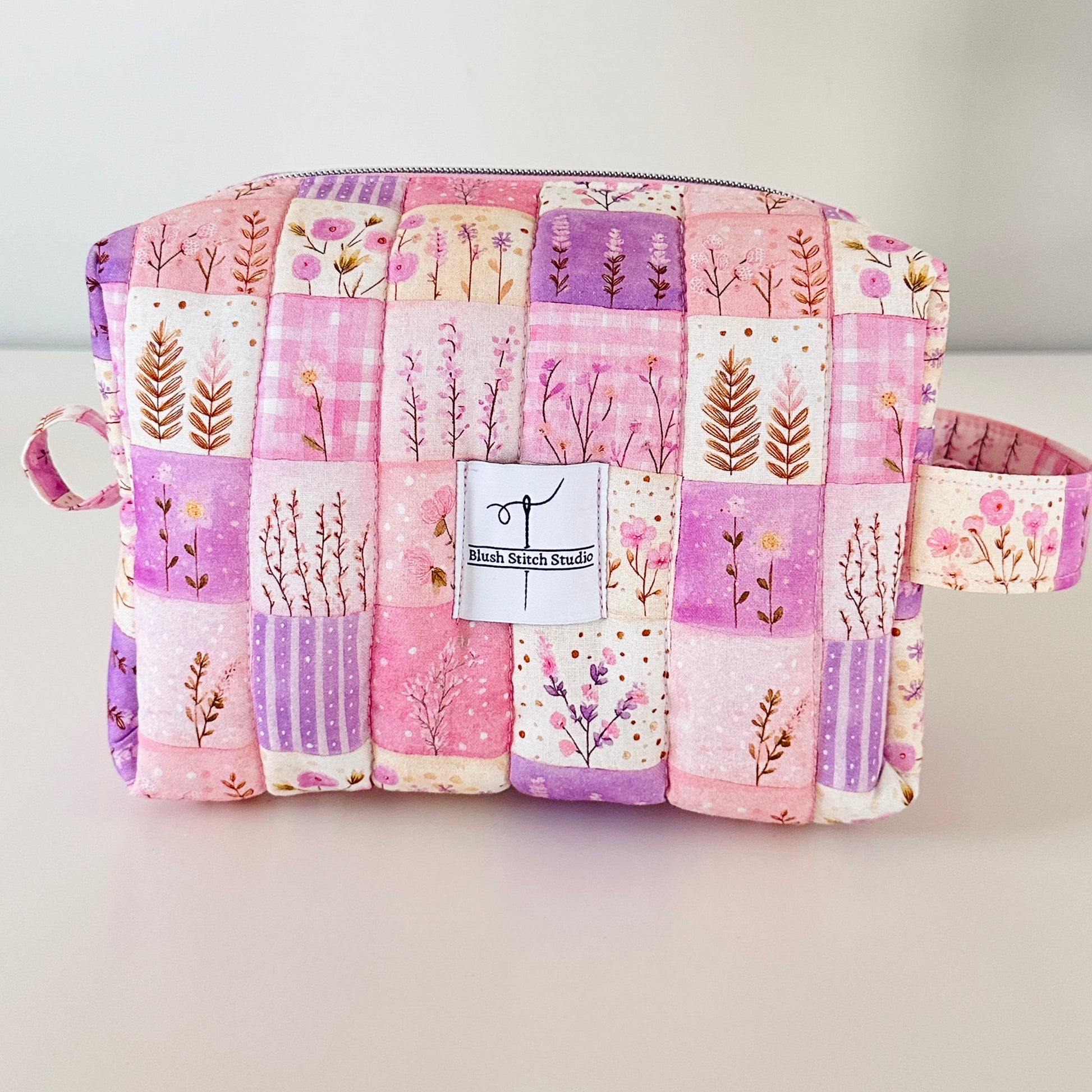 Patchwork pouch with floral patterns on a light gray background