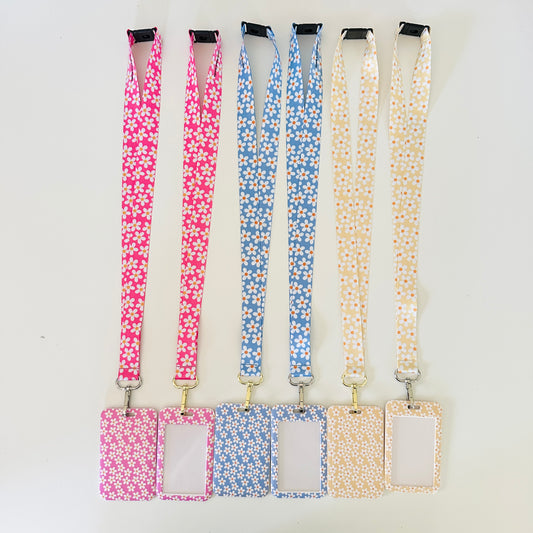 Set of four floral lanyards with attached matching ID Card badge holders tags on a white background
