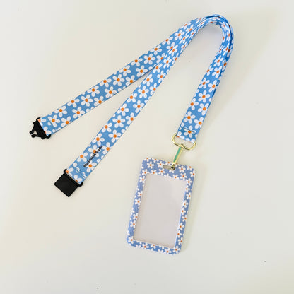 blue daisy floral lanyard with a matching ID holder on a light gray background