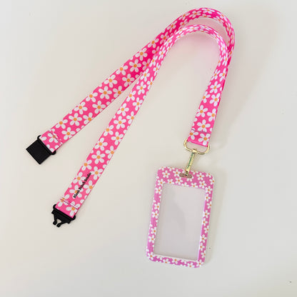 Pink floral lanyard with a matching ID holder on a light gray background