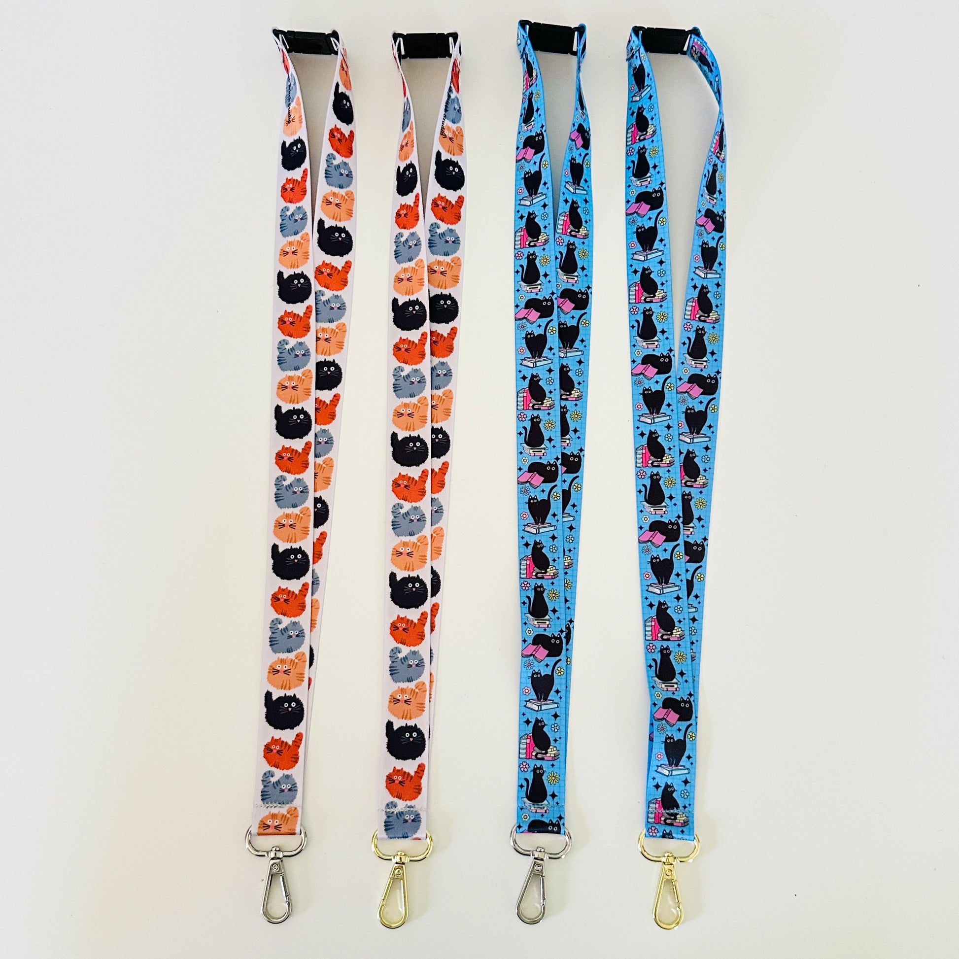 Four lanyards with cat patterns on a white background