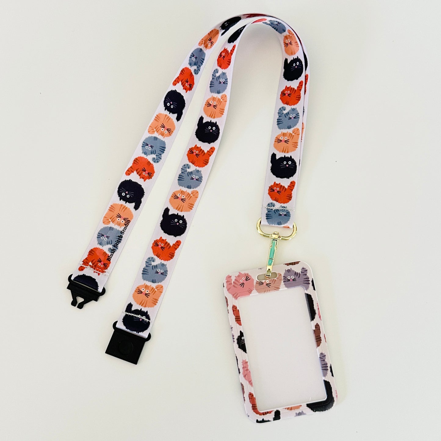 Lanyard with cat pattern and attached cardholder on a white background