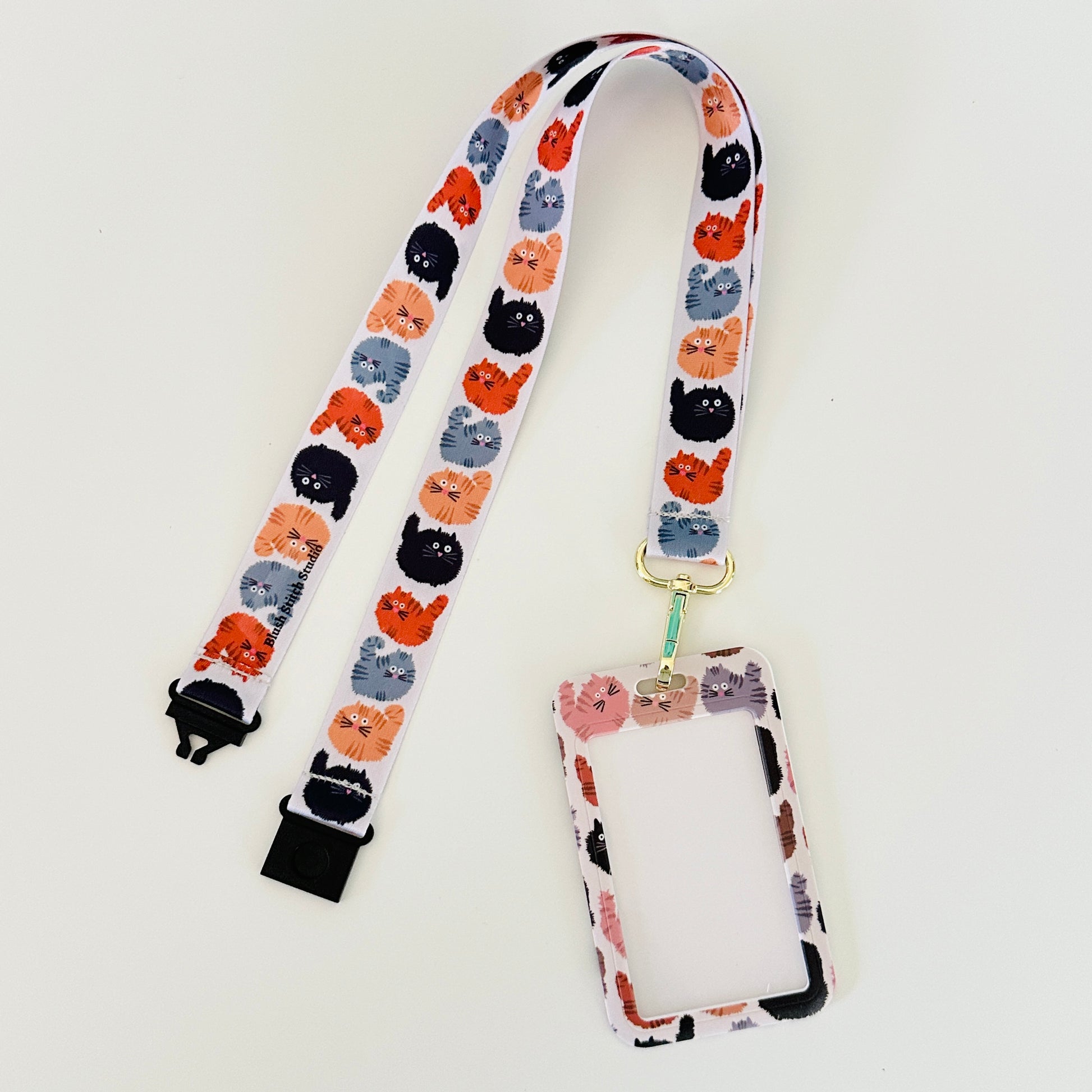 Lanyard with cat pattern and attached cardholder on a white background