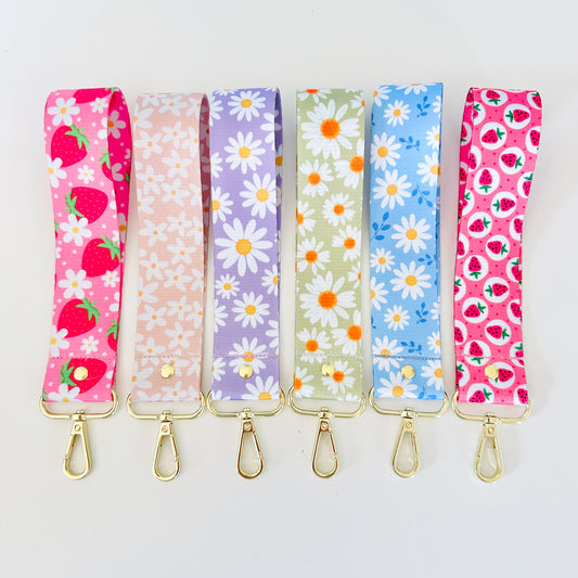 Set of six floral patterned keychains wristlet on a white background