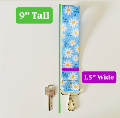 Floral-patterned keychain with dimensions labeled on a white background