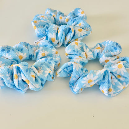 blue daisy floral scrunchies on a light background