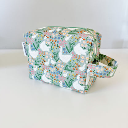 Fabric bag with a green floral and goose pattern on a white background