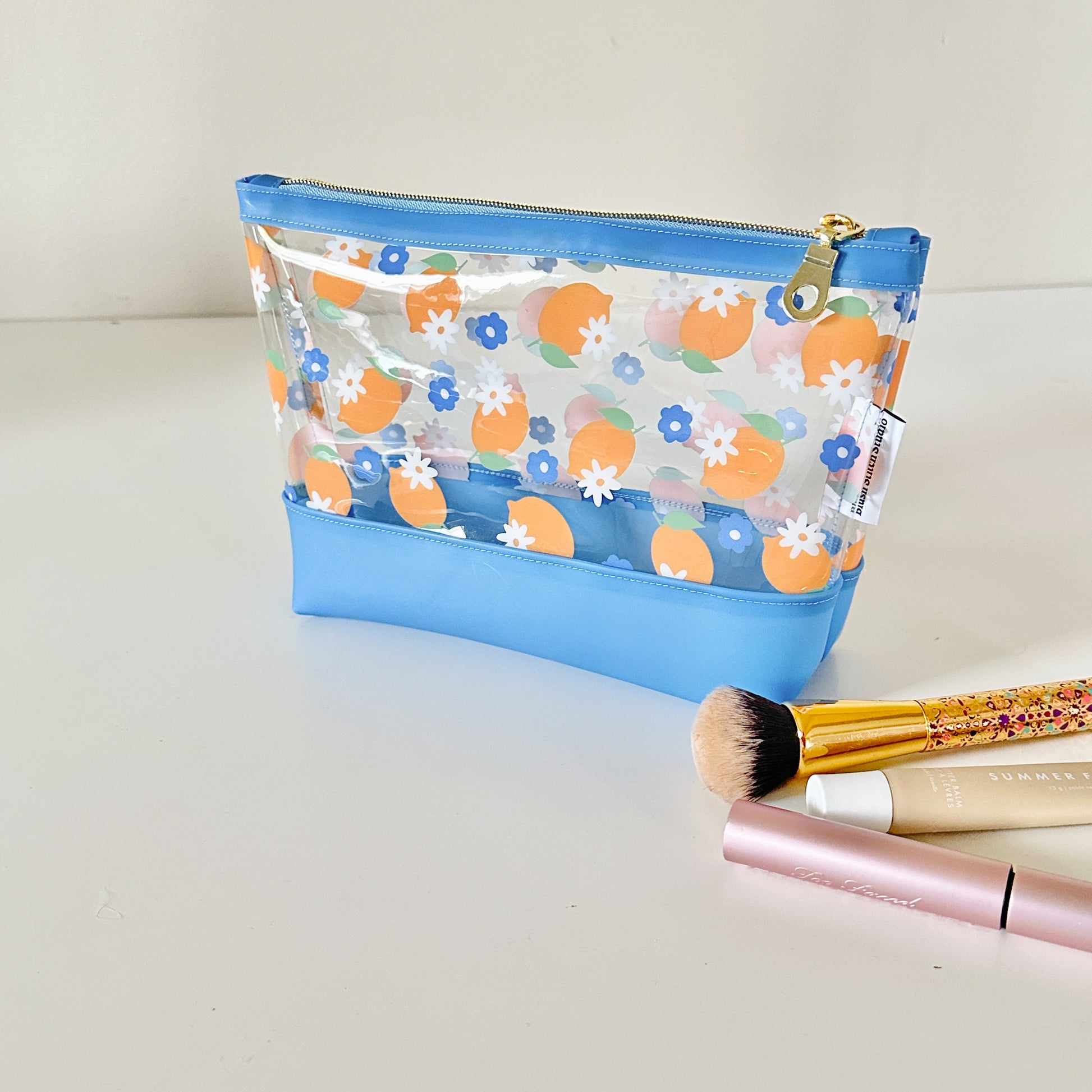 clear makeup bag with a blue and yellow lemon pattern