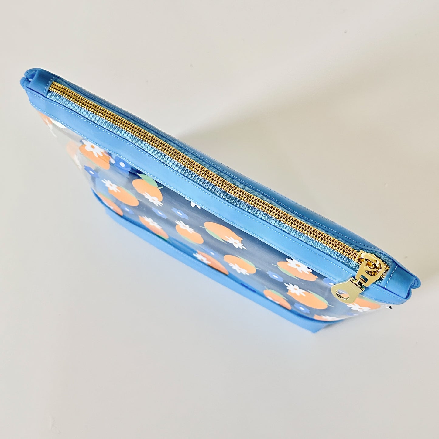 clear makeup bag with a blue and yellow lemon pattern