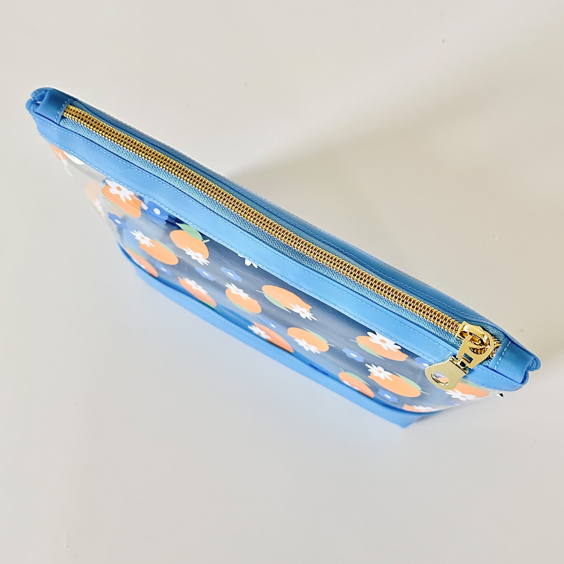 clear makeup bag with a blue and yellow lemon pattern