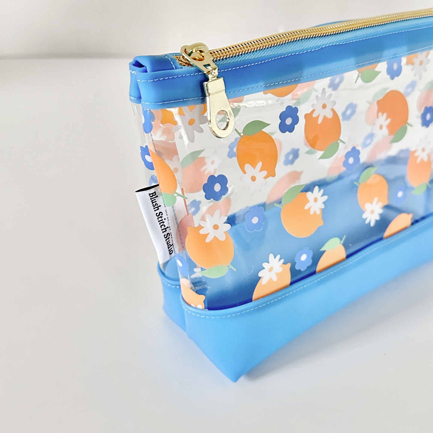 clear makeup bag with a blue and yellow lemon pattern