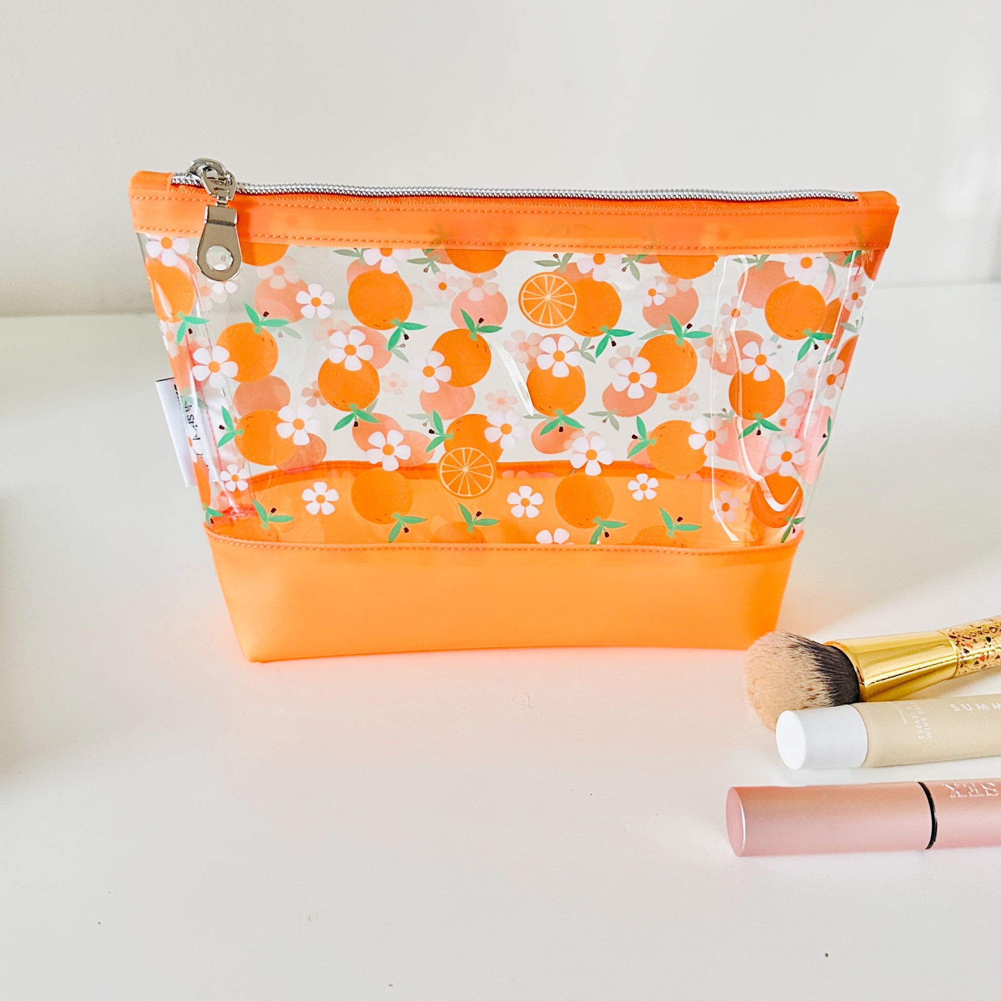 Clear pouch with white floral pattern on a light gray background