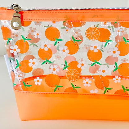 Clear pouch with white floral pattern on a light gray background