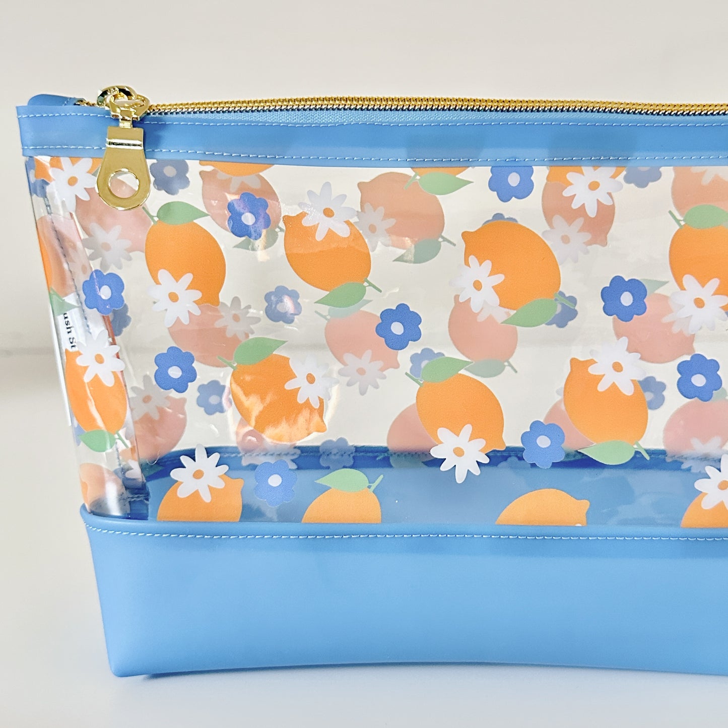 clear makeup bag with a blue and yellow lemon pattern