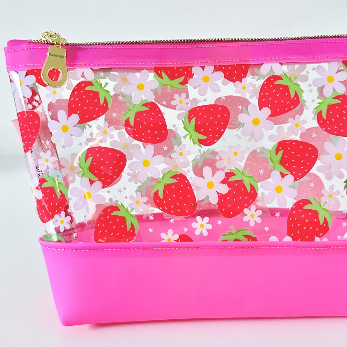 clear makeup bag with a pink strawberry pattern