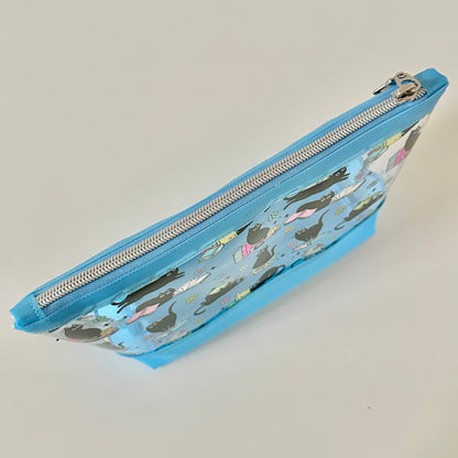 clear makeup bag with a black cat and book pattern blue bottom