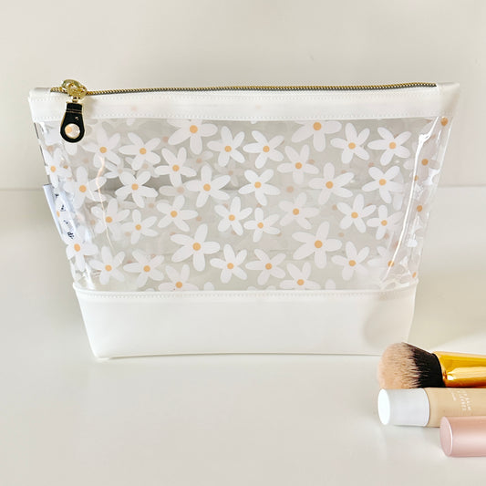 Clear pouch with white floral pattern on a light gray background