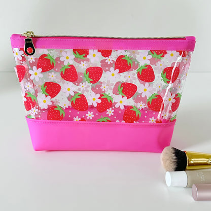 clear makeup bag with a pink strawberry pattern