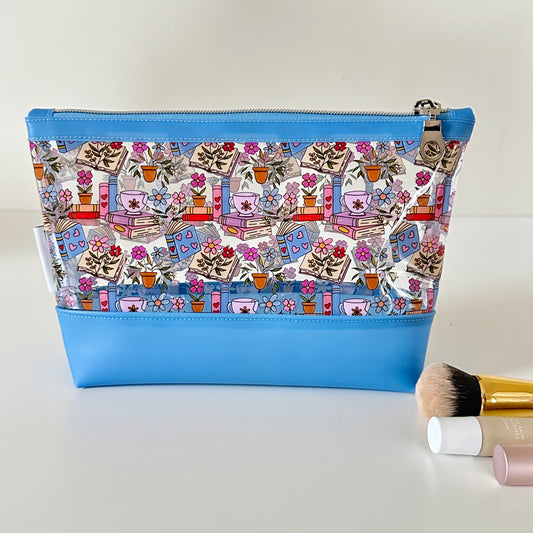 clear makeup bag with floral and book design on a white background