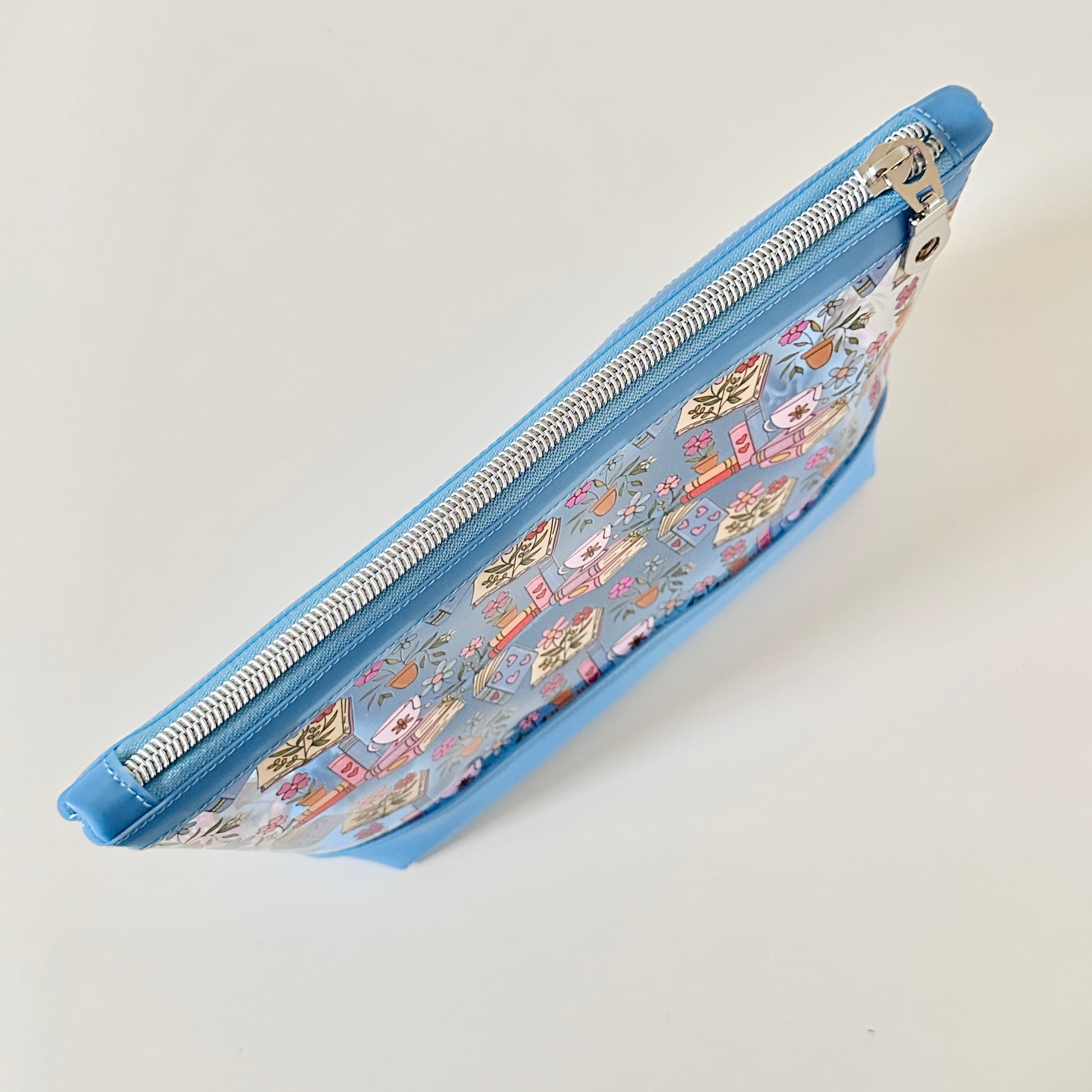 clear makeup bag with floral and book design