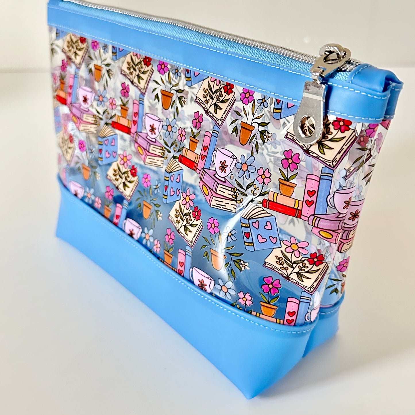 clear makeup bag with floral and book design