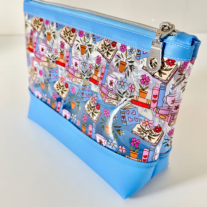 clear makeup bag with floral and book design