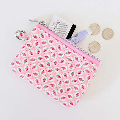 Pink strawberry coin purse on a white background
