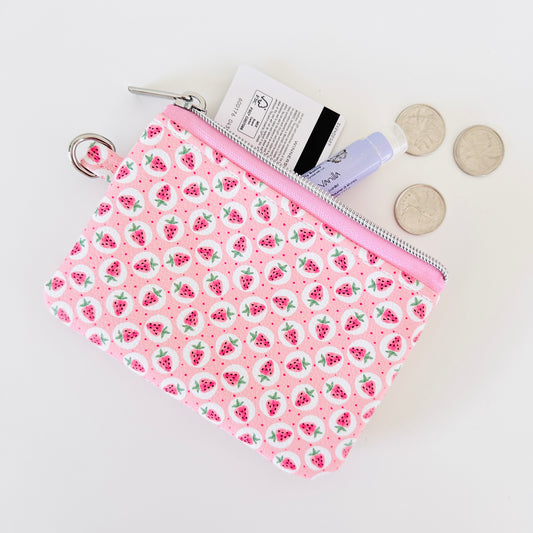 Pink strawberry coin purse on a white background